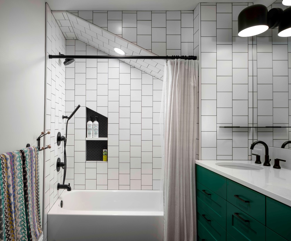 This is an example of a large transitional kids bathroom in Portland with recessed-panel cabinets, green cabinets, an alcove tub, a shower/bathtub combo, a one-piece toilet, white tile, ceramic tile, white walls, mosaic tile floors, an undermount sink, quartzite benchtops, black floor, a shower curtain and white benchtops.
