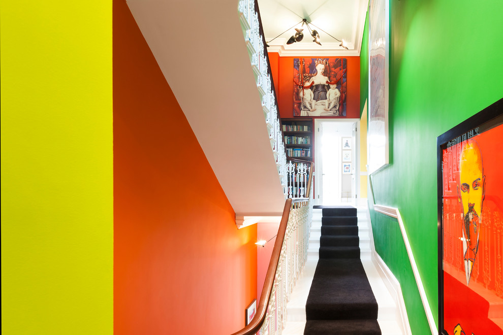 Expansive modern hallway in London with multi-coloured walls and carpet.