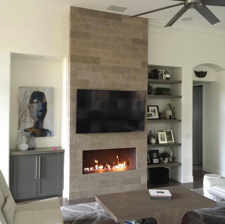 Mid-sized modern enclosed living room in Phoenix with white walls, porcelain floors, a ribbon fireplace, a stone fireplace surround and a wall-mounted tv.