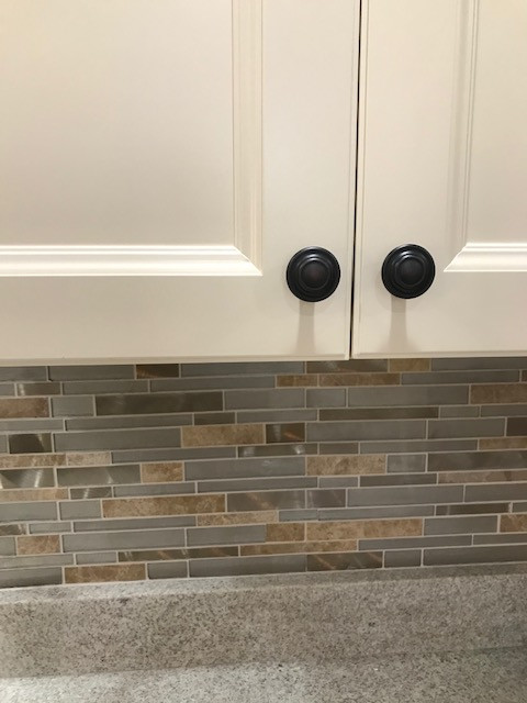 Mid-sized transitional galley porcelain tile and beige floor eat-in kitchen photo with an undermount sink, flat-panel cabinets, beige cabinets, granite countertops, multicolored backsplash, mosaic tile backsplash, stainless steel appliances, a peninsula and white countertops