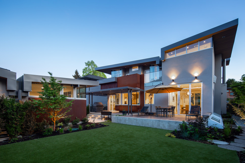 Large modern brown two-story metal house exterior idea in Vancouver with a butterfly roof, a metal roof and a gray roof