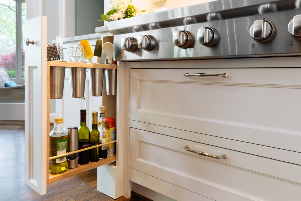 Inspiration for a transitional medium tone wood floor eat-in kitchen remodel in Cincinnati with an undermount sink, recessed-panel cabinets, white cabinets, quartzite countertops, white backsplash and paneled appliances