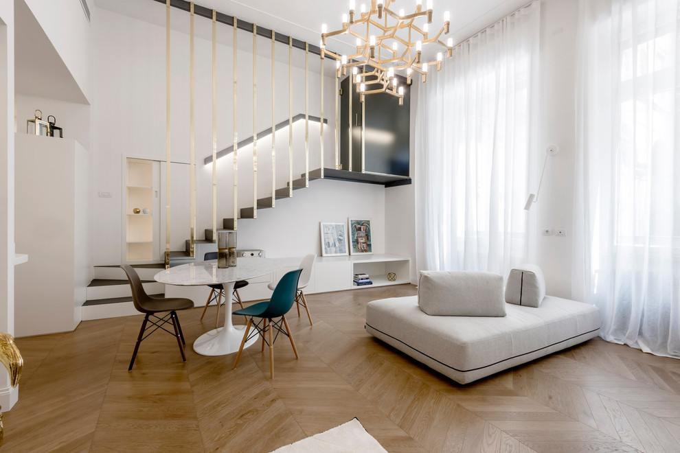 This is an example of a mid-sized contemporary formal open concept living room in Milan with medium hardwood floors.