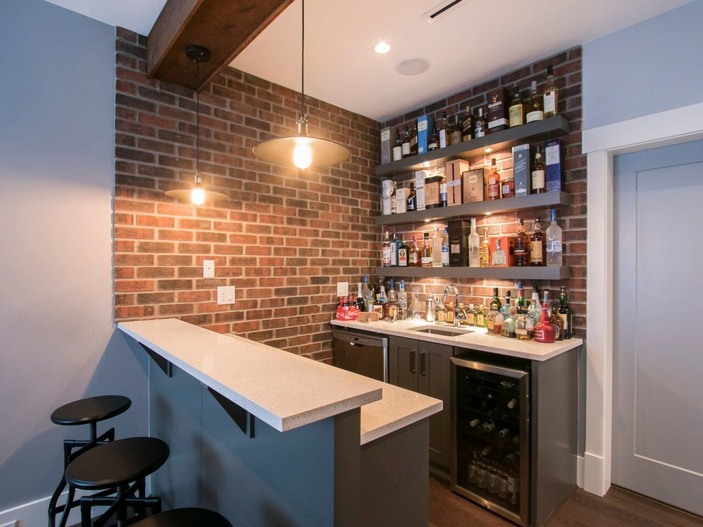 Design ideas for a small transitional single-wall wet bar in Vancouver with an undermount sink, shaker cabinets, grey cabinets, quartz benchtops, multi-coloured splashback, brick splashback, medium hardwood floors and brown floor.