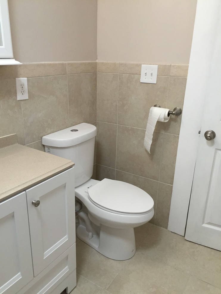 Photo of a mid-sized contemporary 3/4 bathroom in Other with a shower/bathtub combo, beige walls, beaded inset cabinets, white cabinets, an alcove tub, a two-piece toilet, ceramic tile, ceramic floors, an undermount sink and laminate benchtops.