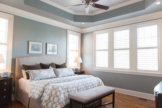 Example of a mid-sized transitional master light wood floor bedroom design in Charlotte with blue walls and no fireplace
