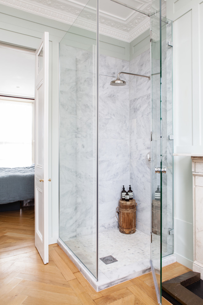 Transitional bathroom in London with a corner shower, green walls and medium hardwood floors.