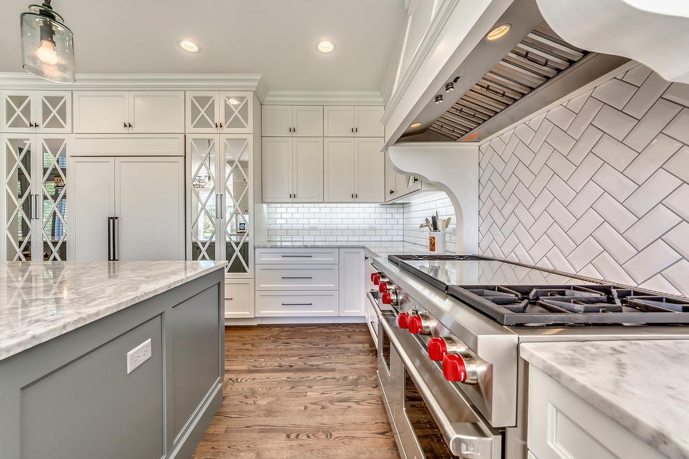 Inspiration for a transitional open concept kitchen remodel in Chicago with white backsplash, subway tile backsplash and two islands