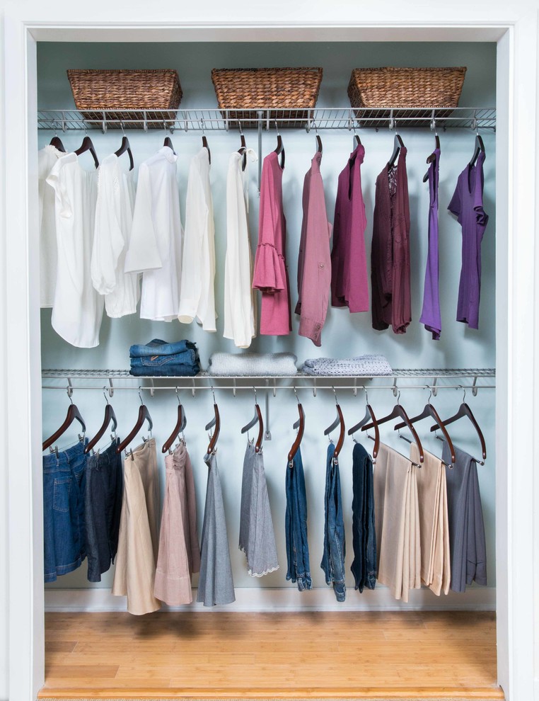 Example of a mid-sized transitional gender-neutral brown floor and light wood floor reach-in closet design with open cabinets