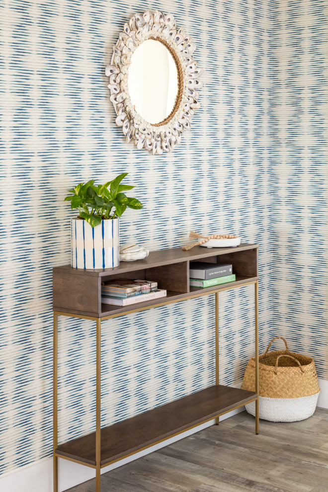 Inspiration for a beach style entryway in New York with multi-coloured walls and light hardwood floors.