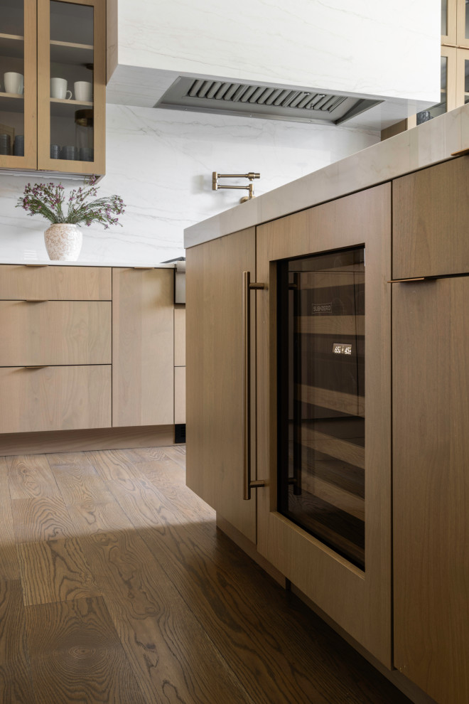 Large trendy u-shaped medium tone wood floor and brown floor open concept kitchen photo in DC Metro with an undermount sink, flat-panel cabinets, medium tone wood cabinets, quartz countertops, white backsplash, quartz backsplash, paneled appliances, an island and white countertops
