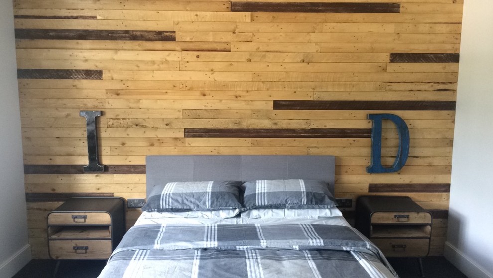 This is an example of a mid-sized country master bedroom in Surrey with brown walls.