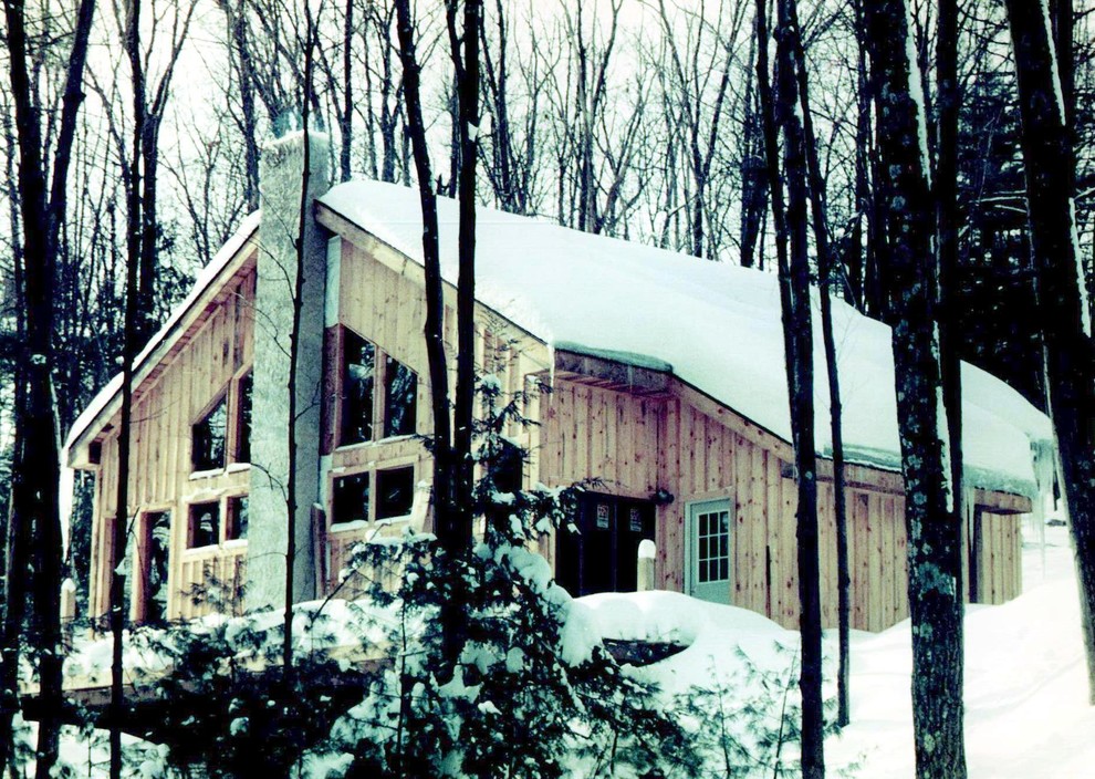 This is an example of a mid-sized country two-storey exterior in New York with wood siding.