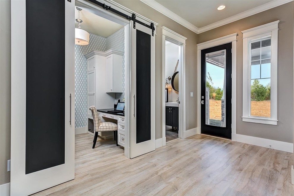 Large traditional foyer in Boise with beige walls, light hardwood floors, a single front door and a black front door.
