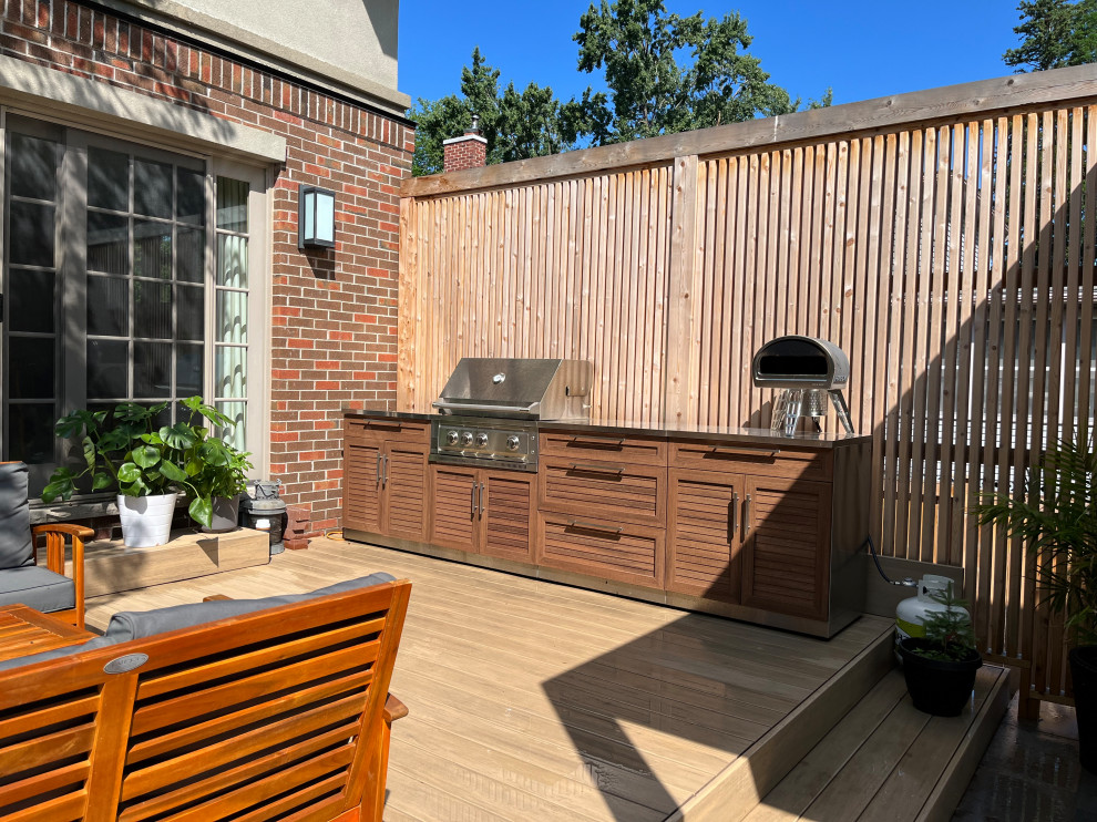 Example of a backyard outdoor kitchen deck design in Ottawa