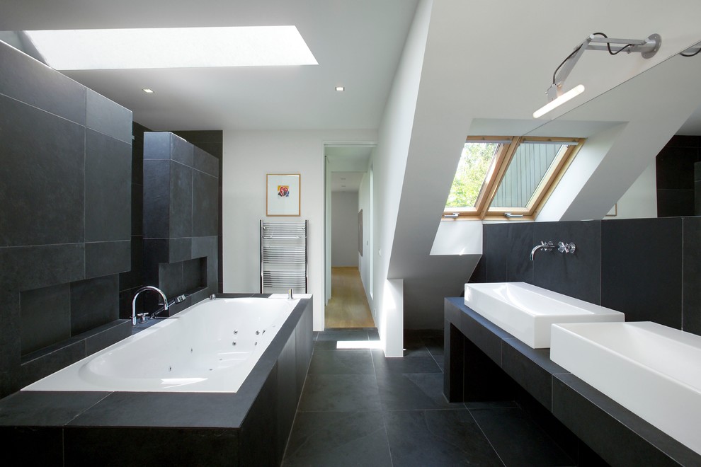 Inspiration for a large contemporary master bathroom in Cologne with a drop-in tub, black tile, stone tile, white walls, slate floors and a vessel sink.