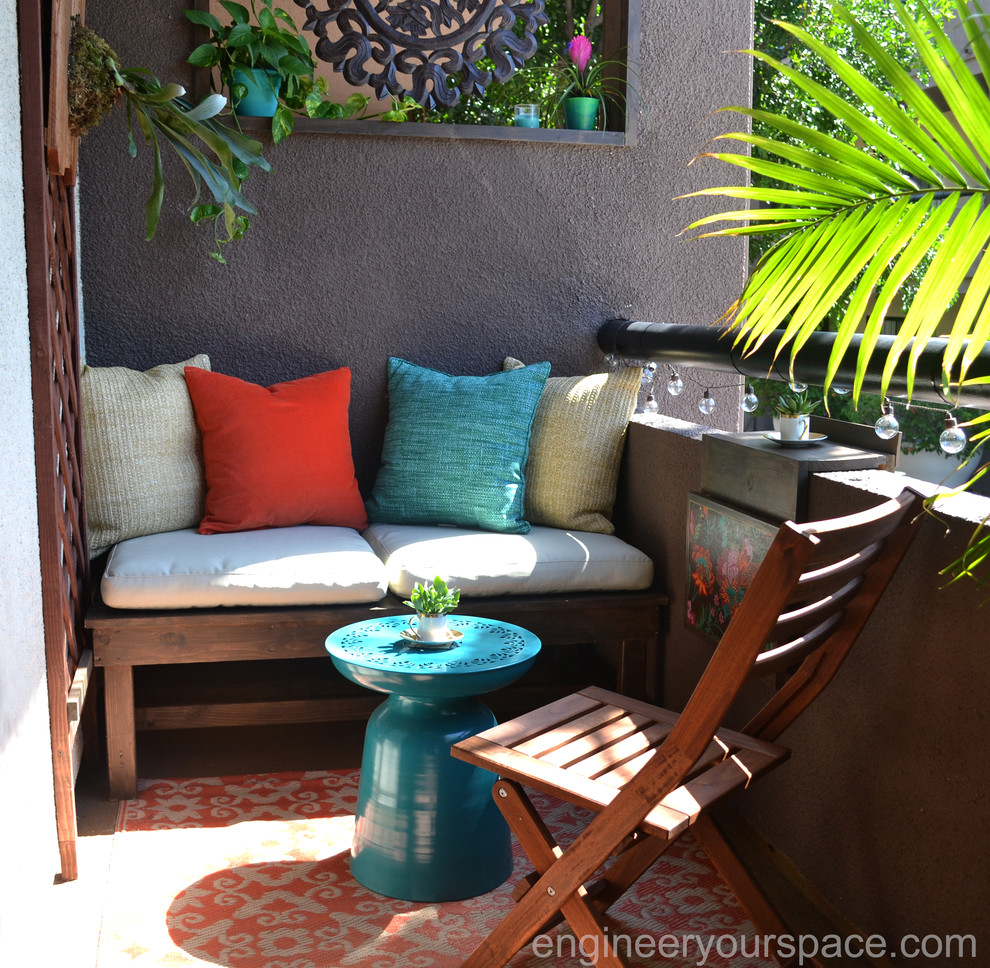 Design ideas for a small tropical patio in Los Angeles with a roof extension.