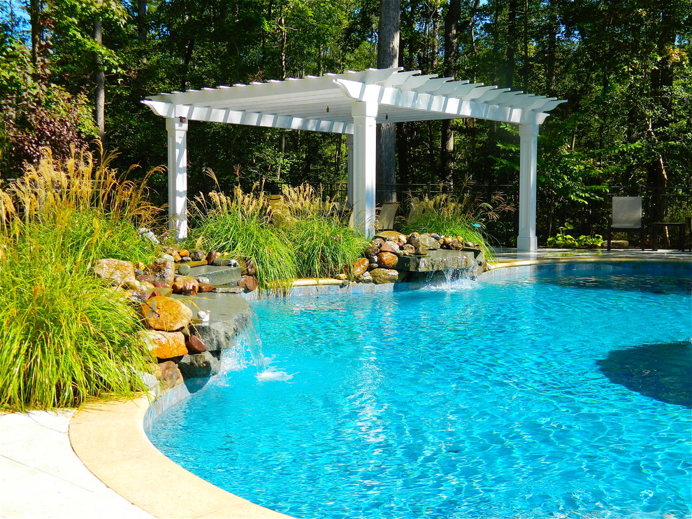 Mid-sized transitional backyard concrete and custom-shaped pool fountain photo