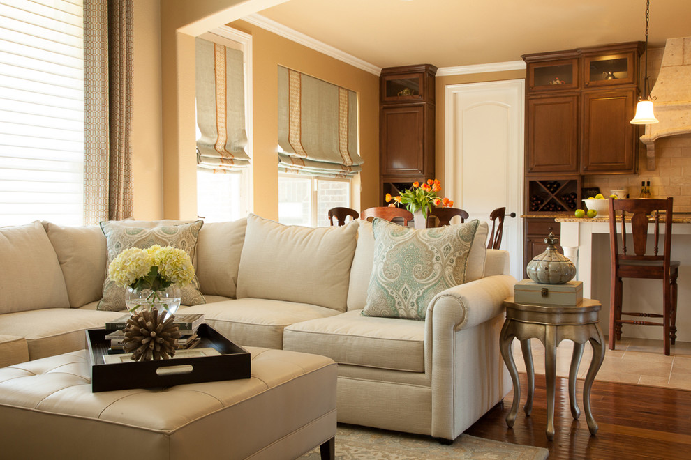 Inspiration for a large traditional open concept living room in Houston with yellow walls and medium hardwood floors.