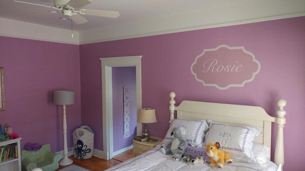 Photo of a mid-sized traditional kids' bedroom for kids 4-10 years old and girls in Charlotte with pink walls, medium hardwood floors and brown floor.