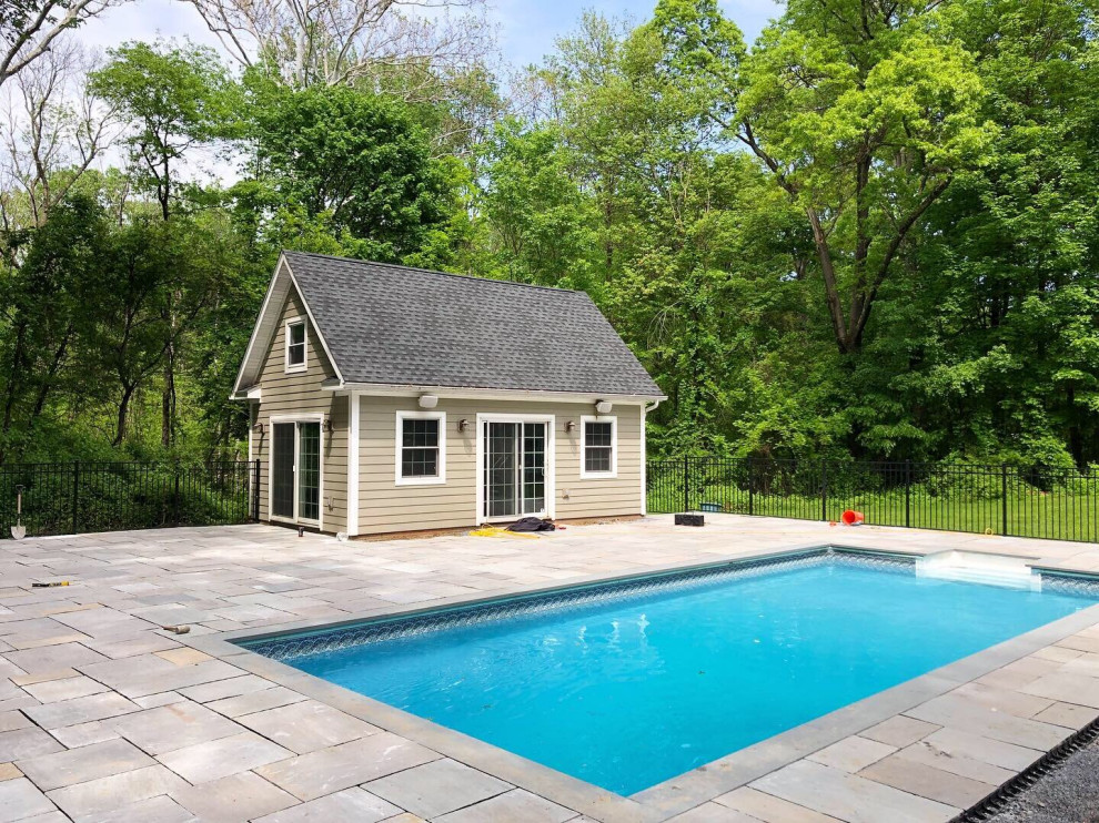Inspiration for a contemporary backyard rectangular natural pool in New York with with a pool and natural stone pavers.