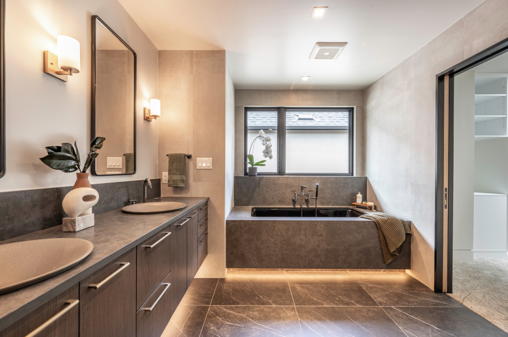 Design ideas for a mid-sized contemporary master bathroom in Denver with flat-panel cabinets, grey cabinets, an undermount tub, gray tile, porcelain tile, grey walls, porcelain floors, a vessel sink, granite benchtops, grey floor, grey benchtops, a double vanity and a floating vanity.