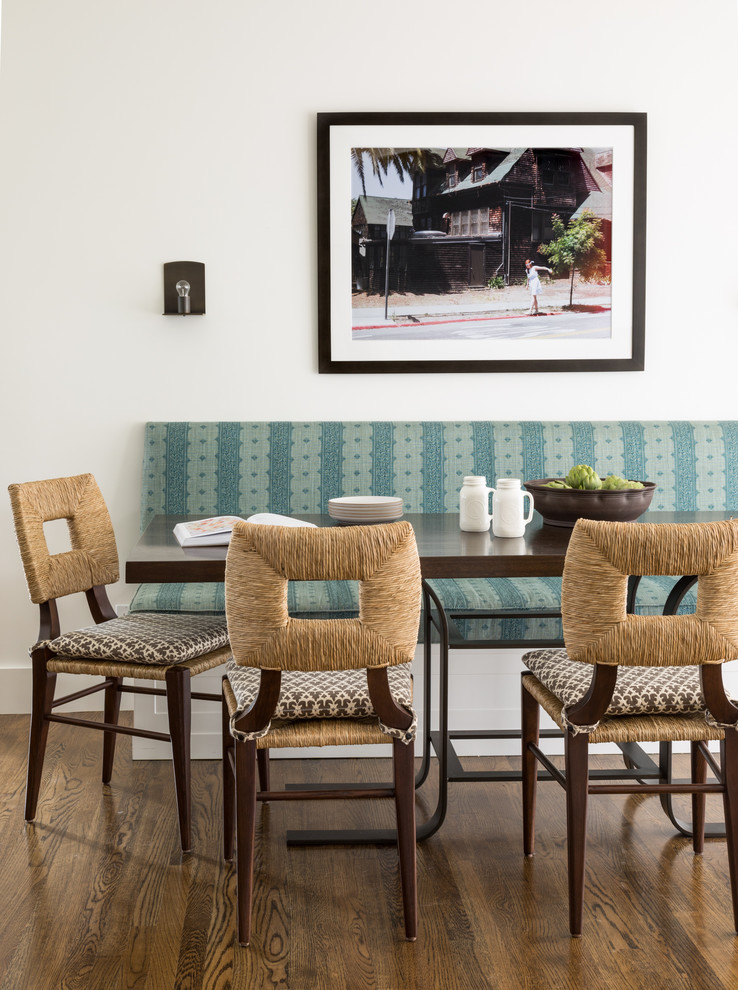 This is an example of a mediterranean open plan dining in San Francisco with white walls, medium hardwood floors and brown floor.