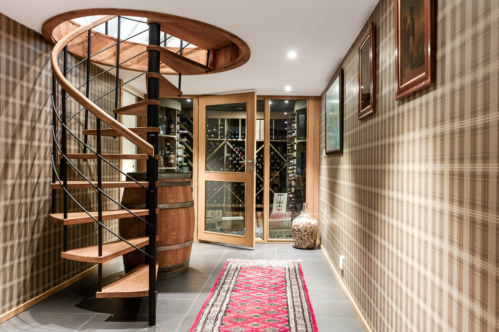 Design ideas for a mid-sized traditional wine cellar in Gothenburg with diamond bins and grey floor.