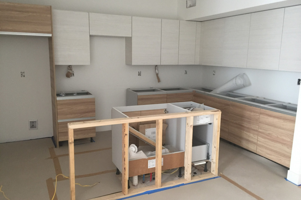 Inspiration for a mid-sized kitchen remodel in Denver with white cabinets and an island