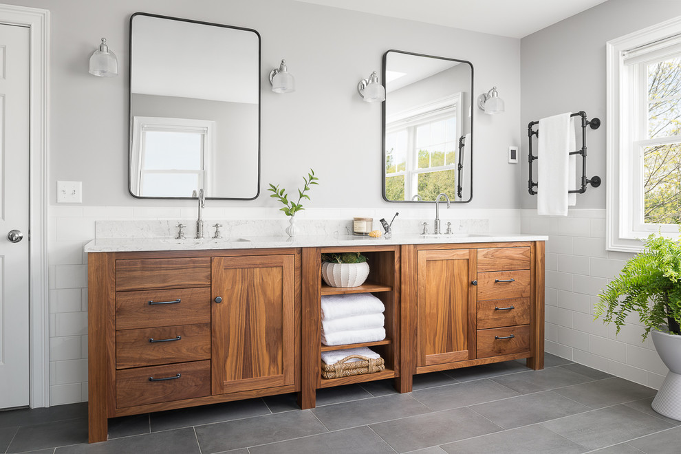 This is an example of a mid-sized beach style master bathroom in Burlington with medium wood cabinets, white tile, ceramic tile, porcelain floors, an undermount sink, grey floor, grey walls, white benchtops and shaker cabinets.
