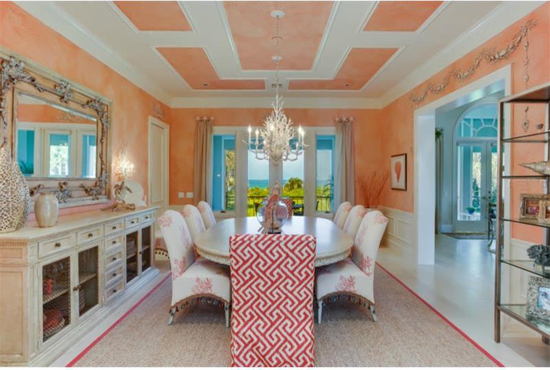 Large mediterranean separate dining room in Tampa with no fireplace and orange walls.