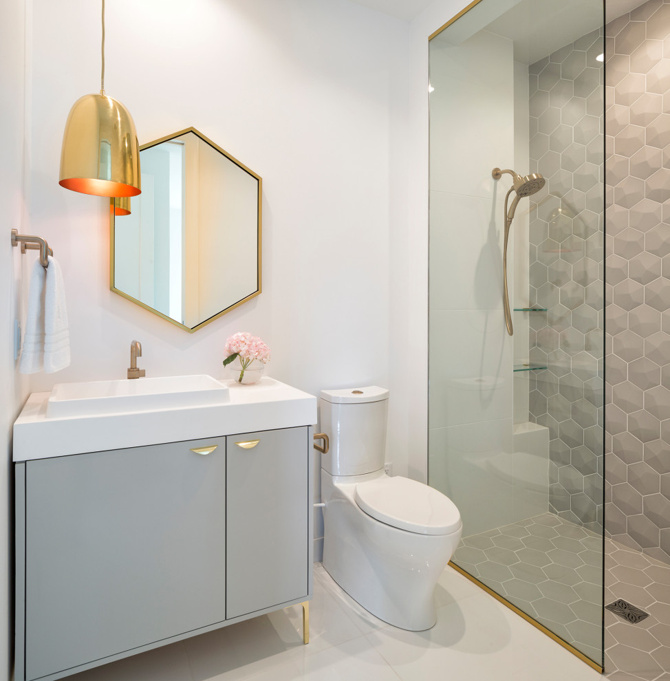 Contemporary 3/4 bathroom in Minneapolis with flat-panel cabinets, grey cabinets, a curbless shower, a two-piece toilet, gray tile, white walls, a vessel sink, white floor, white benchtops, a single vanity and a freestanding vanity.
