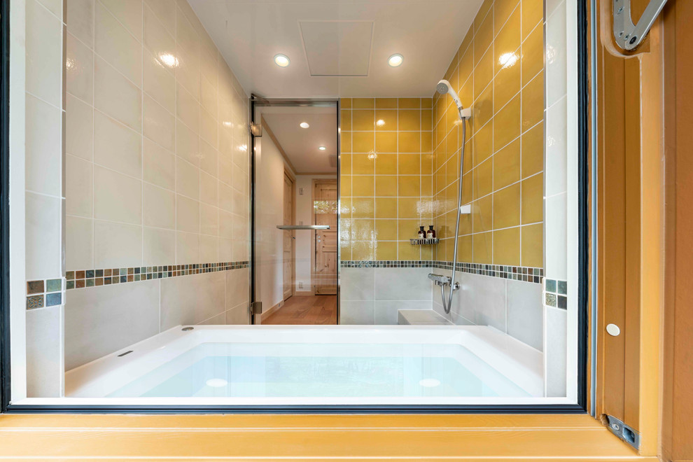 Example of a tuscan porcelain tile, beige floor and tray ceiling bathroom design in Tokyo with orange walls