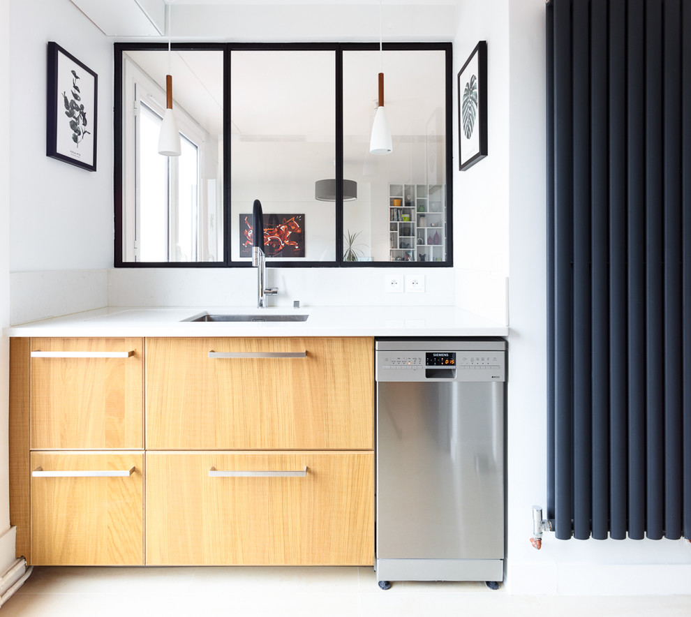 Photo of a small scandinavian separate kitchen in Paris with an undermount sink, flat-panel cabinets, light wood cabinets, white splashback, stainless steel appliances, white floor, white benchtop, quartzite benchtops and no island.