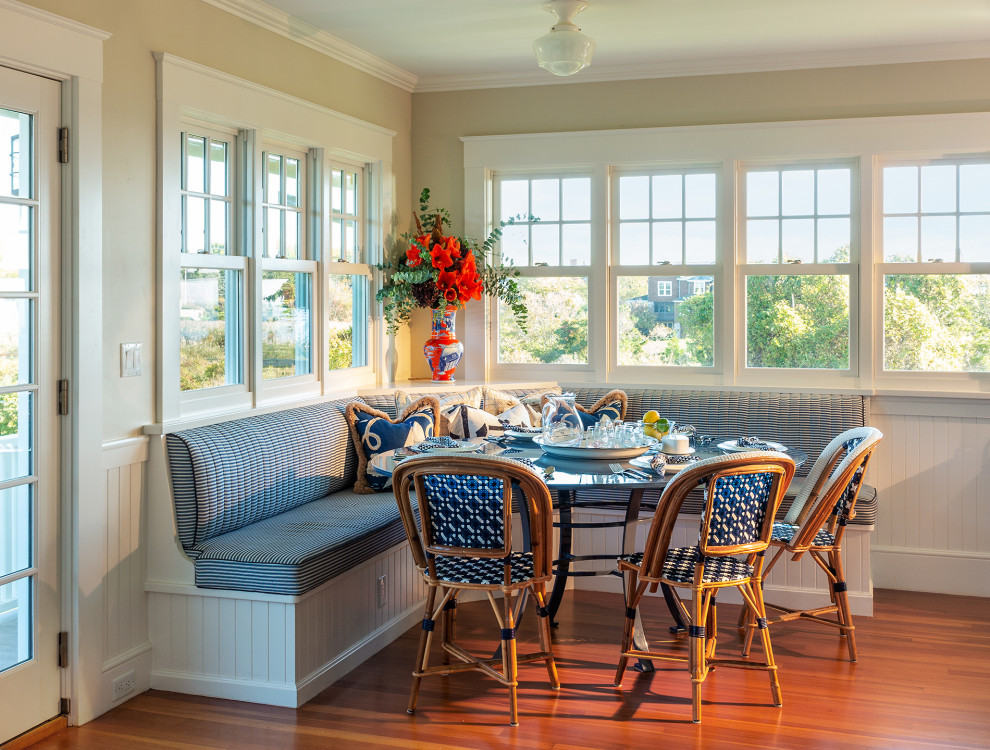 Beach style dining room in Providence with white walls, medium hardwood floors, no fireplace, brown floor, panelled walls and decorative wall panelling.