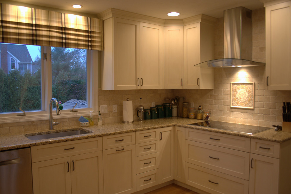Photo of a large transitional u-shaped eat-in kitchen in Boston with an undermount sink, recessed-panel cabinets, beige cabinets, granite benchtops, beige splashback, stone tile splashback, stainless steel appliances, medium hardwood floors and a peninsula.