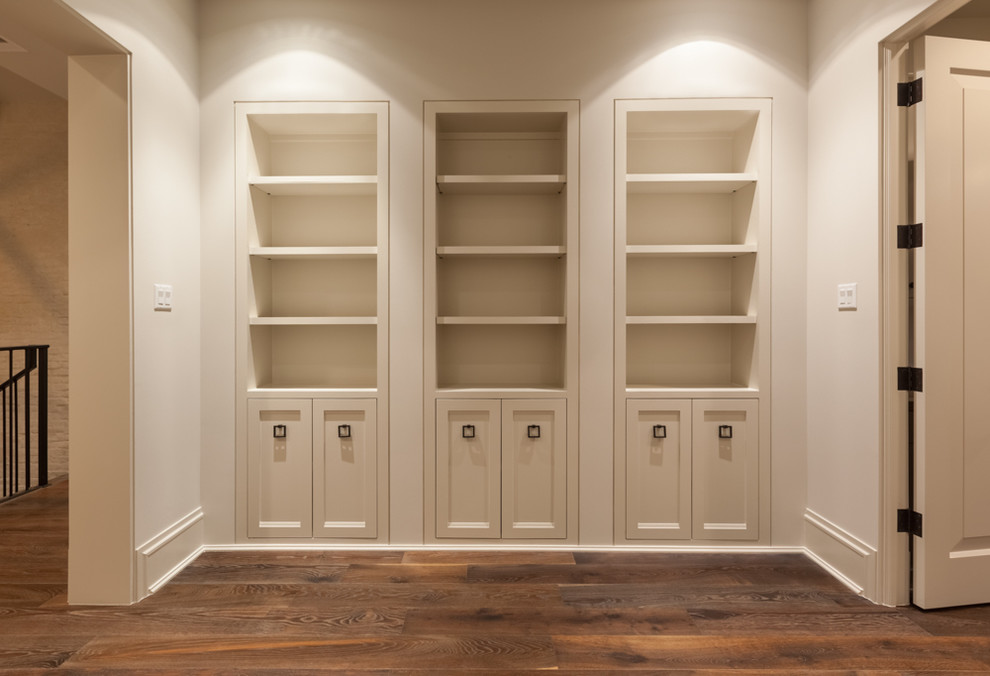 Example of a large transitional medium tone wood floor hallway design in Houston with beige walls