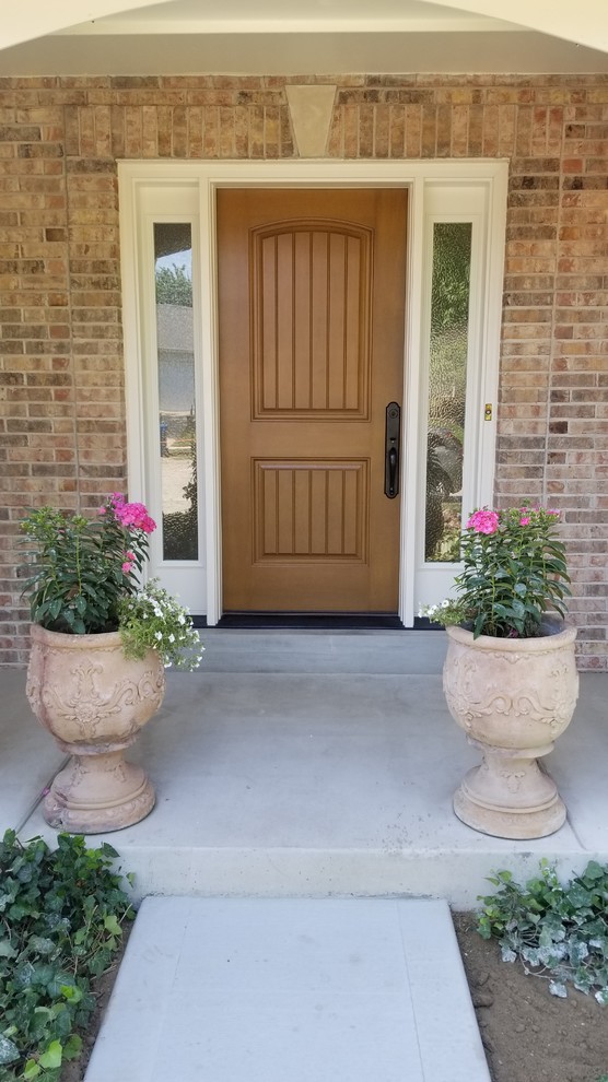 Mid-sized traditional front door in St Louis with a single front door and a medium wood front door.