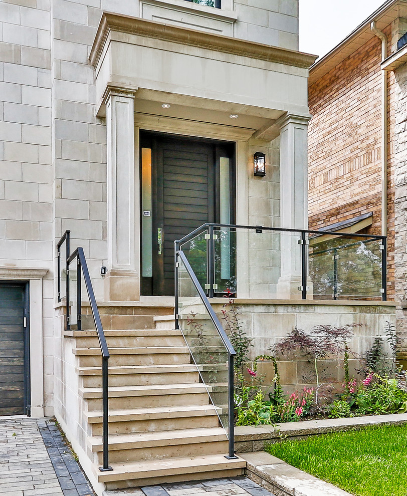 Photo of a mid-sized contemporary front yard verandah in Toronto.