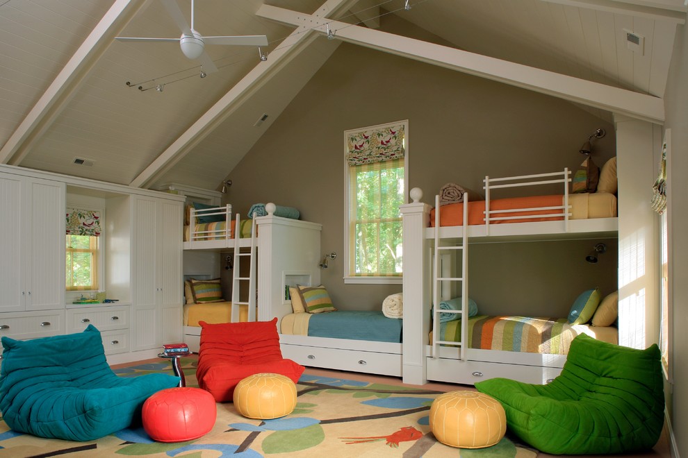 Photo of a large beach style gender-neutral kids' bedroom for kids 4-10 years old in Grand Rapids with beige walls and carpet.