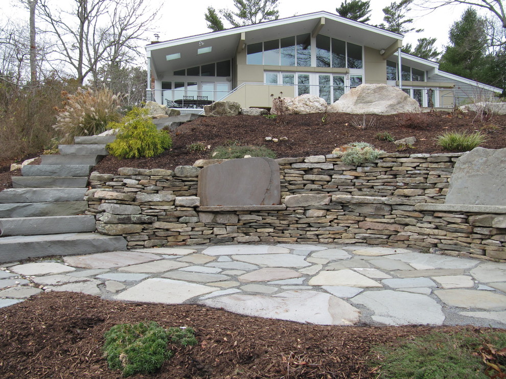 Photo of a mid-sized traditional backyard patio in Boston with natural stone pavers and no cover.