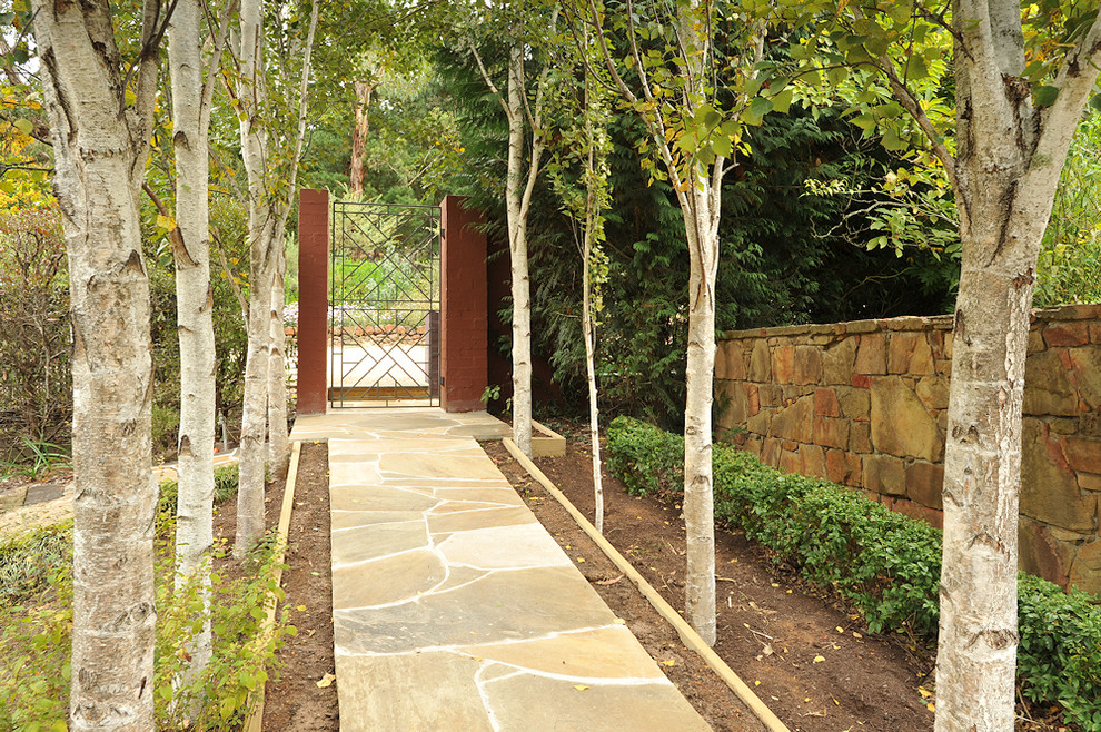 Design ideas for an eclectic shaded garden for fall in Melbourne with a garden path and natural stone pavers.