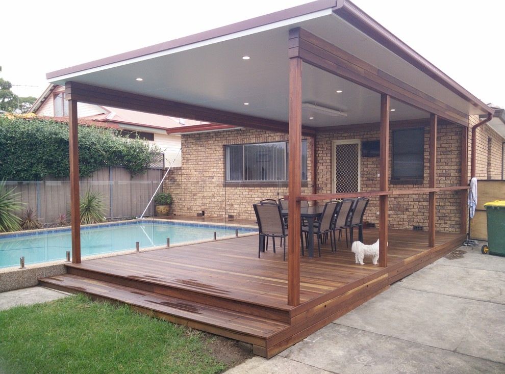 Inspiration for a mid-sized modern backyard deck in Sydney with a pergola.