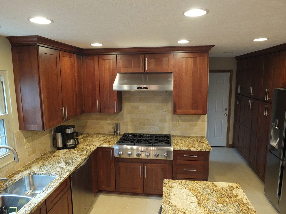 Eat-in kitchen - mid-sized transitional l-shaped ceramic tile eat-in kitchen idea in Columbus with an undermount sink, shaker cabinets, brown cabinets, granite countertops, beige backsplash, ceramic backsplash, stainless steel appliances and an island