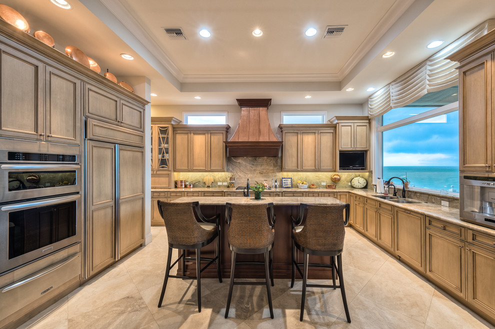 This is an example of a tropical l-shaped kitchen in Miami with a double-bowl sink, beaded inset cabinets, brown cabinets, brown splashback, stainless steel appliances and with island.