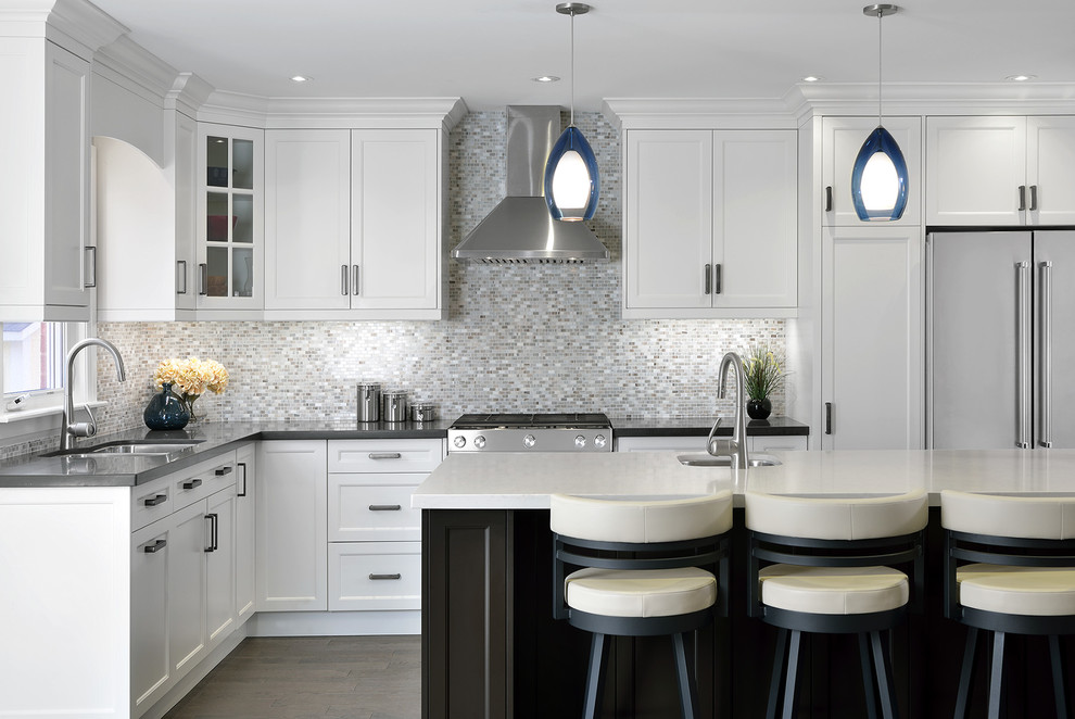 Inspiration for a transitional l-shaped kitchen in Toronto with shaker cabinets, white cabinets, quartz benchtops, grey splashback, stainless steel appliances, with island, an undermount sink, mosaic tile splashback and dark hardwood floors.