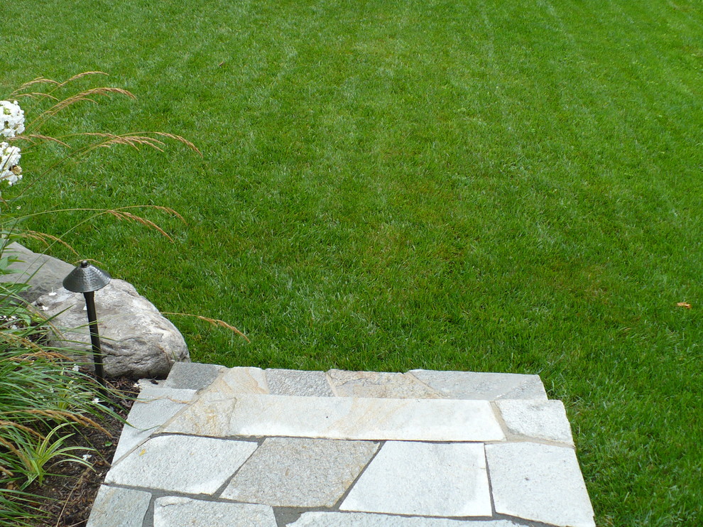 Photo of a rustic backyard stone landscaping in Baltimore.