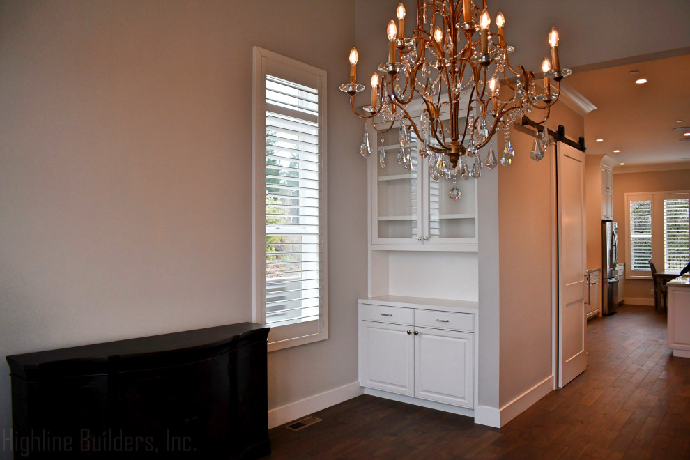 Arts and crafts dining room in San Francisco with grey walls, dark hardwood floors and brown floor.