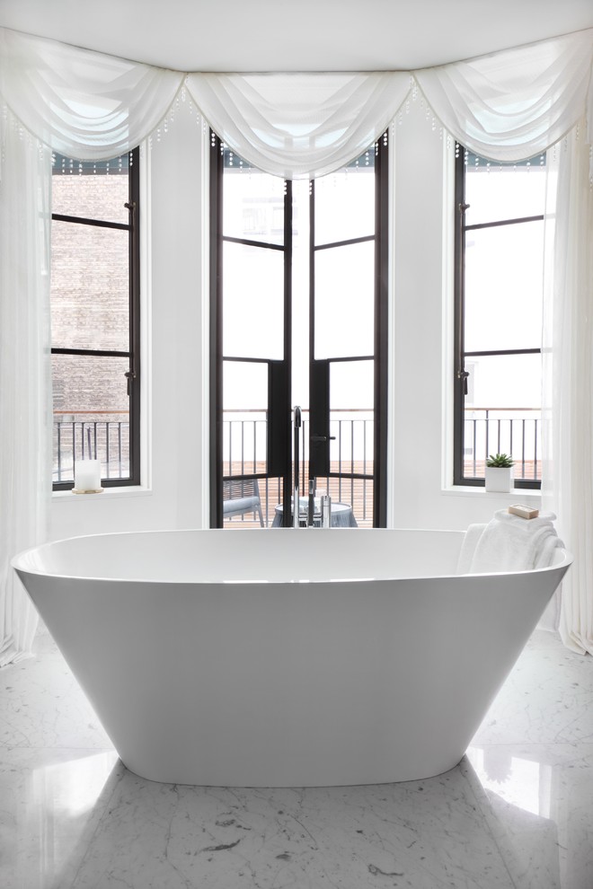 Design ideas for a contemporary bathroom in London with a freestanding tub.