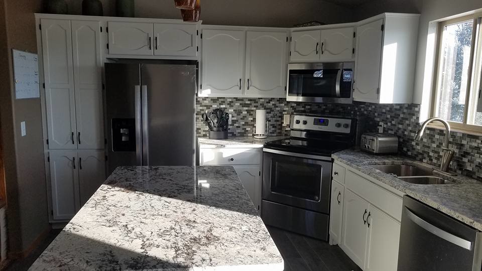Enclosed kitchen - mid-sized transitional l-shaped dark wood floor and brown floor enclosed kitchen idea with a double-bowl sink, recessed-panel cabinets, white cabinets, granite countertops, multicolored backsplash, mosaic tile backsplash, stainless steel appliances, an island and gray countertops